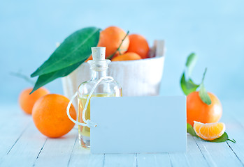 Image showing tangerines and oil in bottle