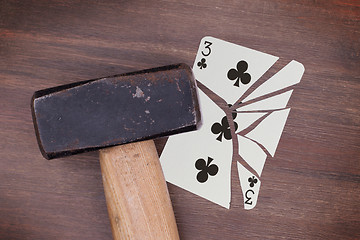 Image showing Hammer with a broken card, three of clubs