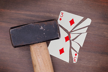 Image showing Hammer with a broken card, three of diamonds