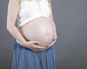 Image showing Woman holding her baby bump