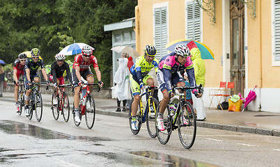 Image showing Group of Cyclists Riding in the Rain