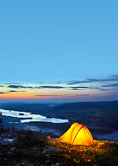 Image showing A tent lit up at dusk