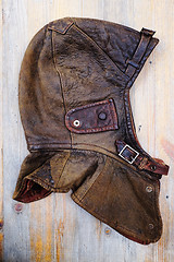 Image showing leather vintage helmet over wooden background