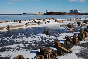 Image showing remains of a wooden pier and ships in port