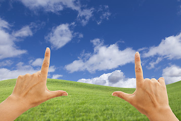 Image showing Female Hands Framing Deep Blue Sky Above Grass Field