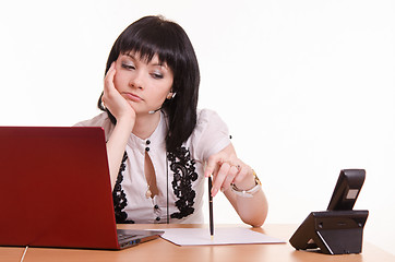 Image showing Thoughtful call-center employee office with pen in hand