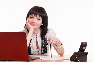 Image showing Call-center employee at a desk with pen in hand