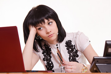 Image showing Thoughtful employee call-center front of monitor leaned her head on