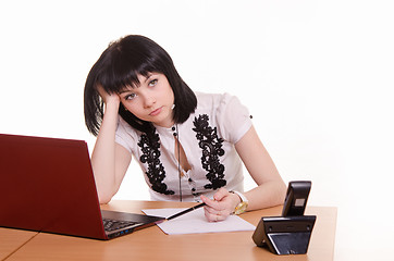 Image showing Call-center worker wondered front of monitor, leaned her head on