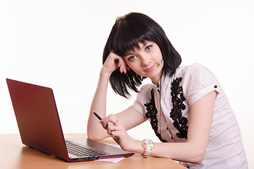 Image showing Call-center employee at desk rests his head on 