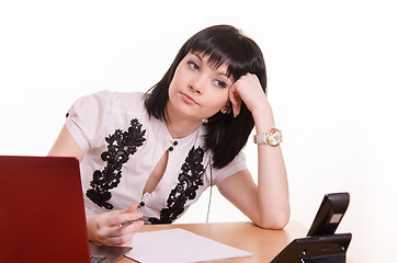 Image showing Thoughtful call-center employee leaned her head on