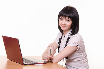 Image showing Smiling girl - call-center employee at the desk