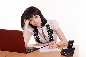 Image showing Tired worker call-center front of monitor, leaned her head on