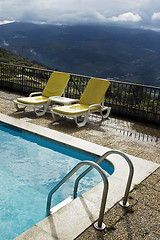 Image showing Long chairs by the pool 3