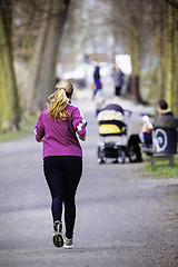 Image showing Sized woman jogging in park