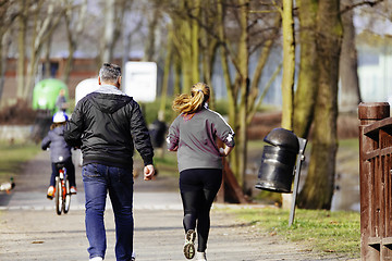 Image showing Sized woman jogging in park