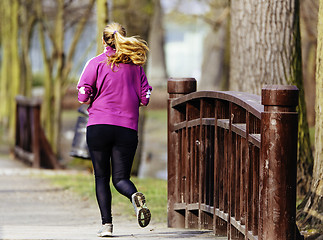 Image showing Sized woman jogging in park