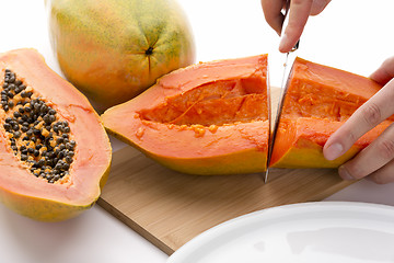 Image showing First Cut Through A Hollowed Out Papaya Half