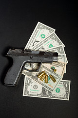 Image showing gun with bullet on US dollar banknotes