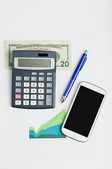 Image showing USA dollar money banknotes, calculator and mobile phone