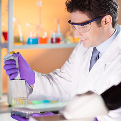 Image showing Researcher pipetting in laboratory.