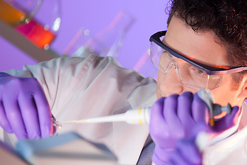 Image showing Life scientist pipetting.