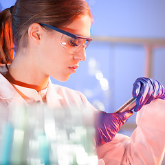 Image showing Young scientist with a smarth phone.