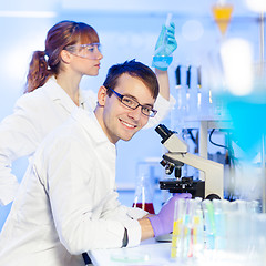 Image showing Portrait of a young male researcher microscoping