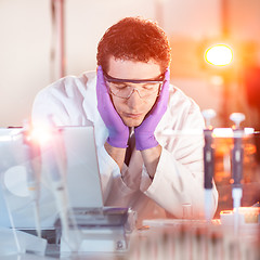 Image showing Researcher sleeping at workplace.