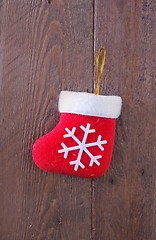 Image showing red sock on wooden board