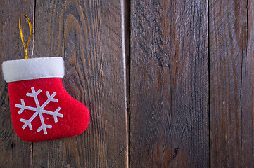 Image showing red sock on wooden board