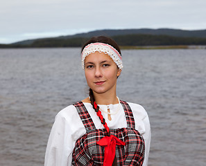 Image showing Young girl in national dress at the river shore