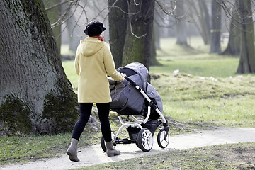 Image showing Young mother with  pram 