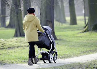 Image showing Young mother with  pram 