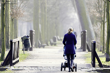 Image showing Young mother with  pram 