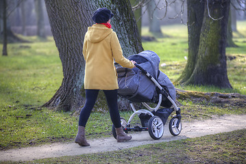 Image showing Young mother with  pram 