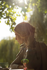 Image showing portrait of a beautiful young woman in park.