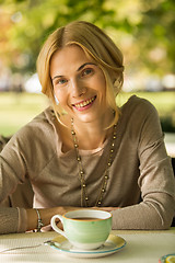 Image showing portrait of a beautiful young woman in park.