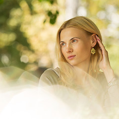 Image showing portrait of a beautiful young woman in park.