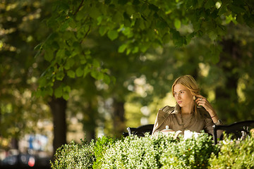 Image showing portrait of a beautiful young woman in park.