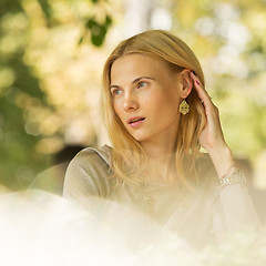 Image showing portrait of a beautiful young woman in park.