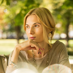 Image showing portrait of a beautiful young woman in park.