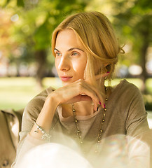 Image showing portrait of a beautiful young woman in park.