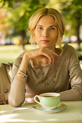 Image showing portrait of a beautiful young woman in park.