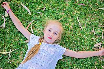 Image showing Caucasian small girl lay on grass