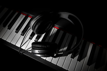 Image showing Piano keyboard with headphones