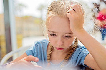 Image showing Little girl sitting outdoor