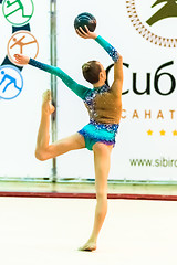 Image showing Young attractive girl shows exercise with ball