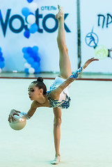 Image showing Young pretty girl shows exercise with ball