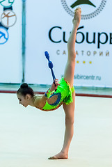 Image showing Young beautiful girl shows exercise with maces